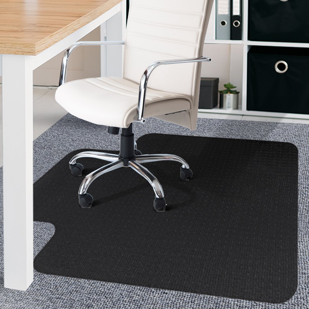 Black PVC chair mat designed for home and office use, featuring a notched stud design for grip and a thickness of 5mm for floor protection.